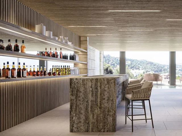 Light-filled indoor bar with bar stools and backlit shelving at Villa Kaizen, La Zagaleta